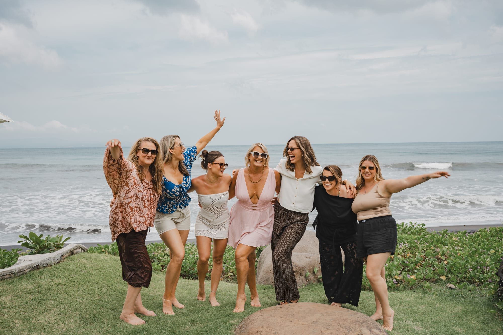 Dee Zibara and a group of women laughing together on a beach